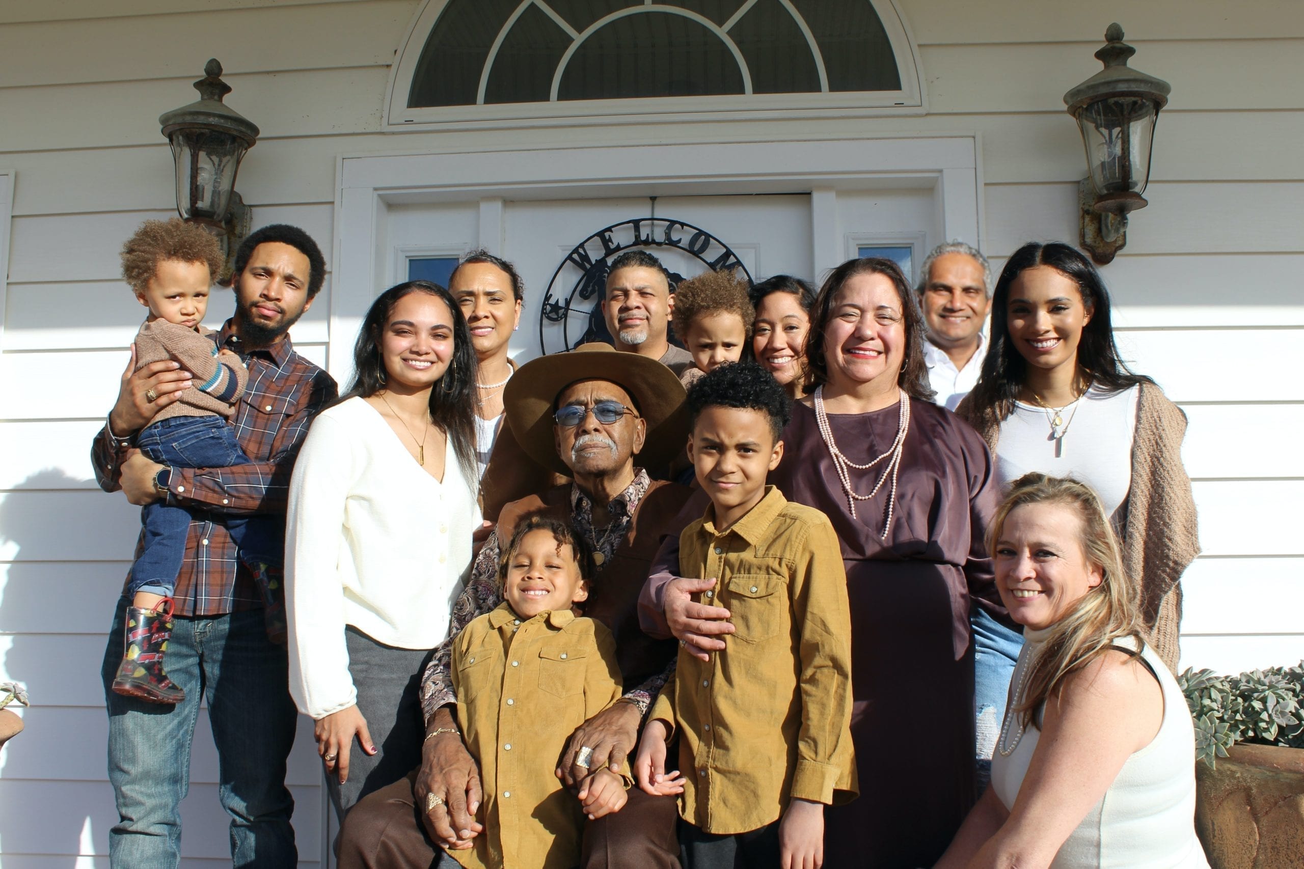 a family photo standing outside of a white house, highlighting what it takes to be a mortgage cosigner
