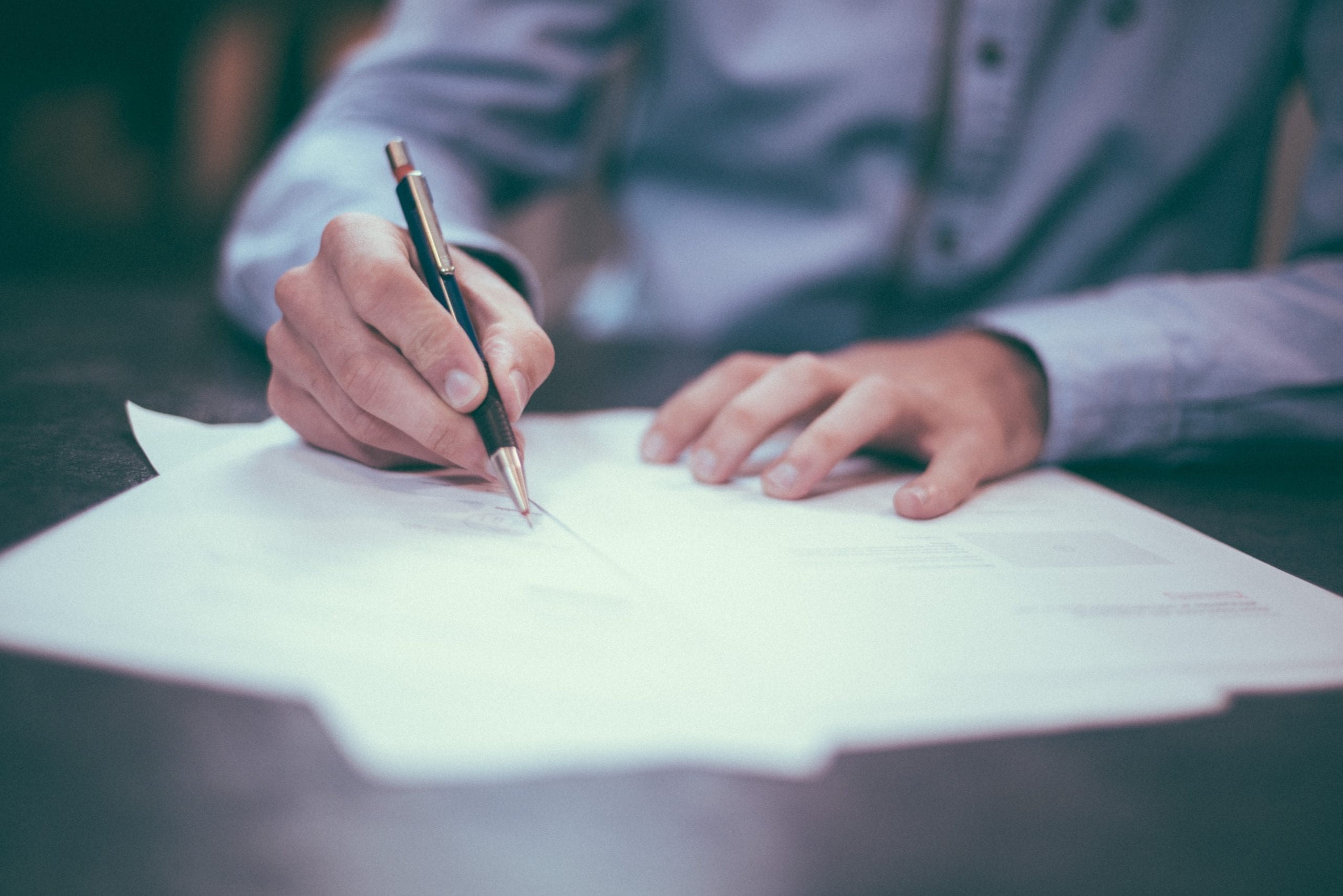 A man signing a missed mortgage payment form