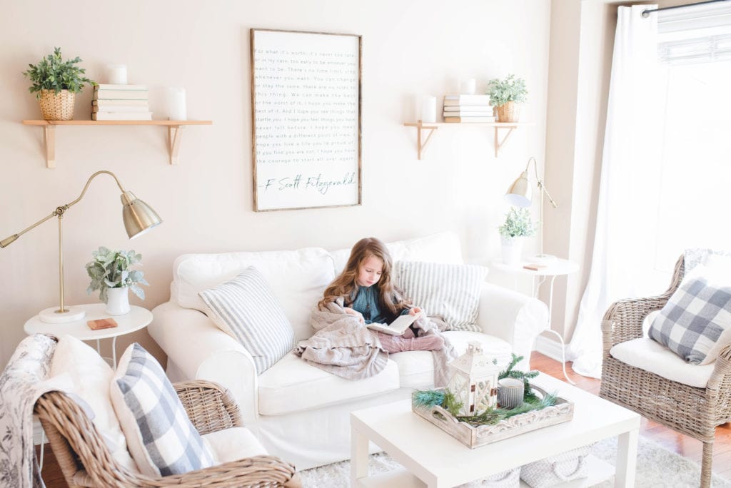A young girl sitting a couch reading in a nicely decorated home, highlighting the chance to keep your existing family home when going through separation or divorce