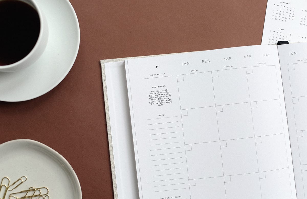 a calendar on a table with a cup of coffee, highlighting that planning is important for mortgage renewals and finding the best rate