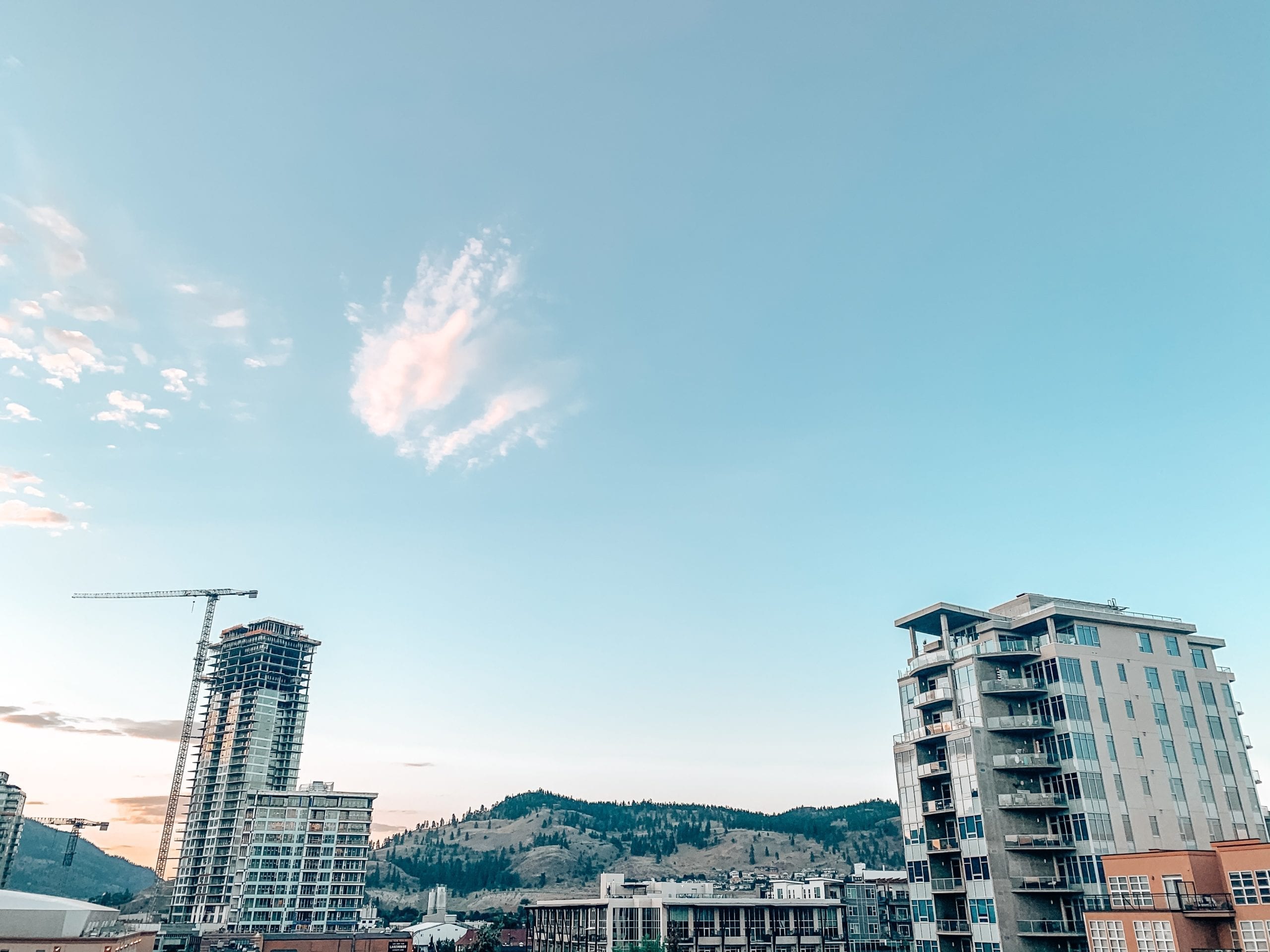downtown kelowna view of new condo construction, in reference to buying a second home but keeping the first