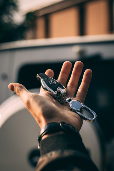 man holding car keys